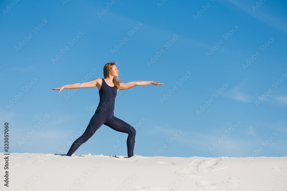 Yoga trainer at desert make warrior pose Yoga trainer at desert make warrior pose