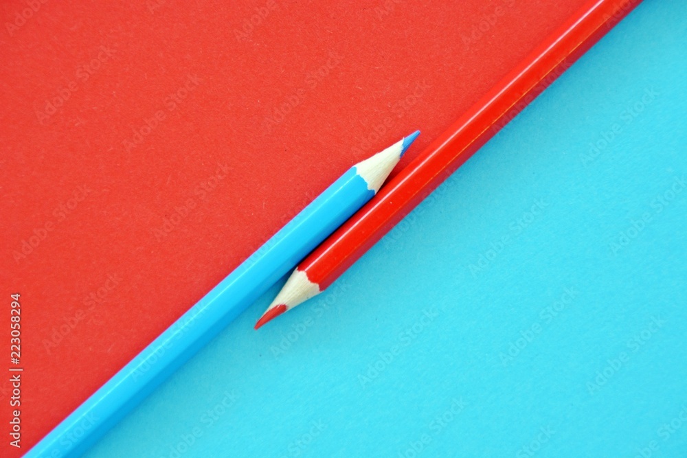 Two colored pencils split a picture in half in two different colors Two colored pencils split a picture in half in two different colors