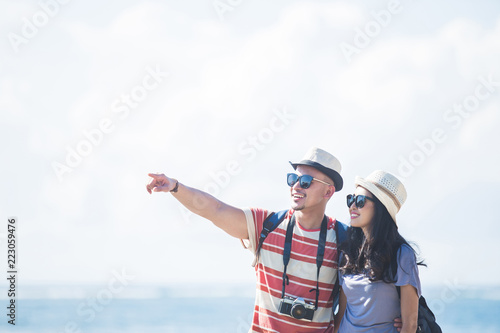 young backpacker with his partner pointing at something during s