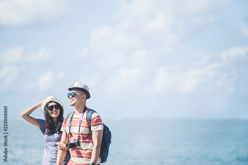 travellers couple wearing summer hat and sunglasses during vacat