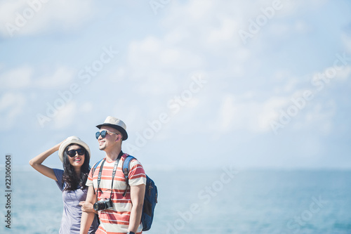 travellers couple wearing summer hat and sunglasses during vacat © Odua Images