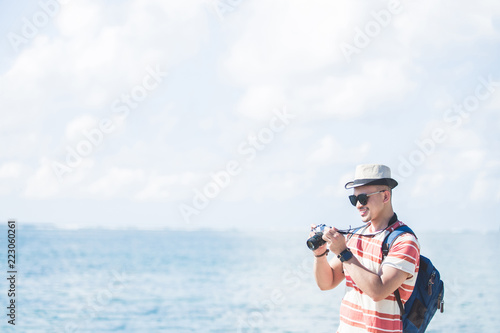 young traveller taking photo using vintage camera