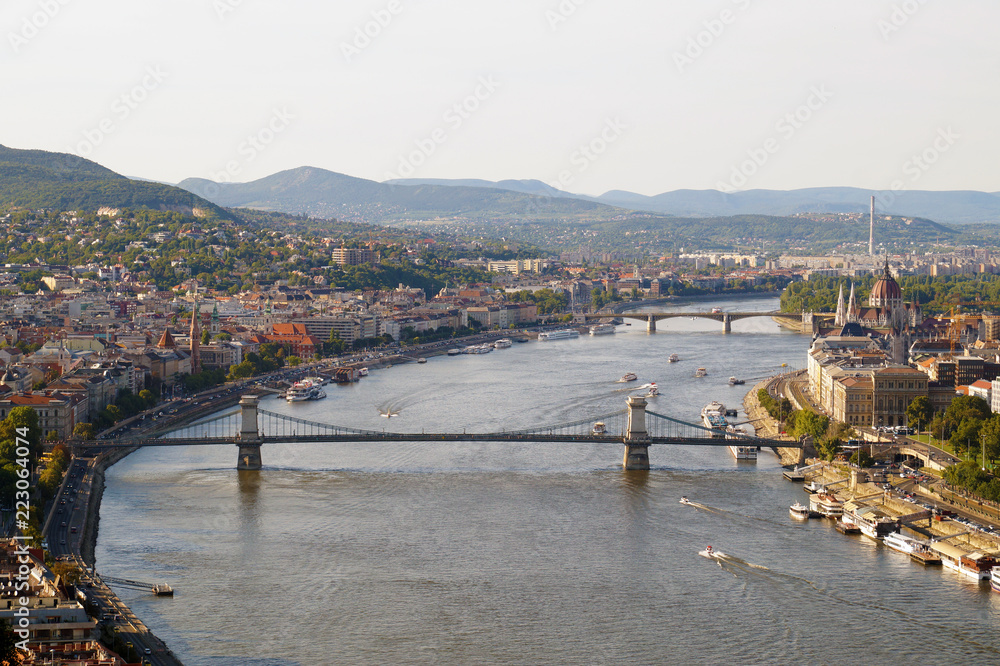 Panorama of the Hungarian capital of Budapest: Parliament on the banks of the Danube and famous bridges.