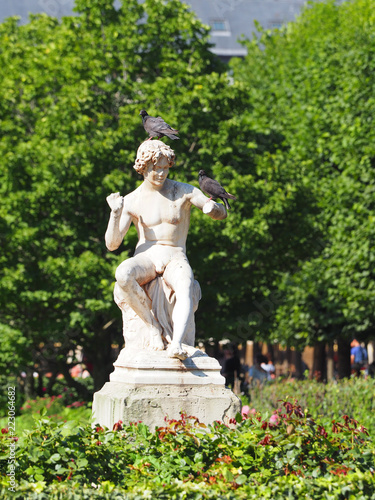 Statue of a boy. Public garden of Royal Palace, Paris, France. Gardens were designed and planted in 1633 by Pierre Desgotz