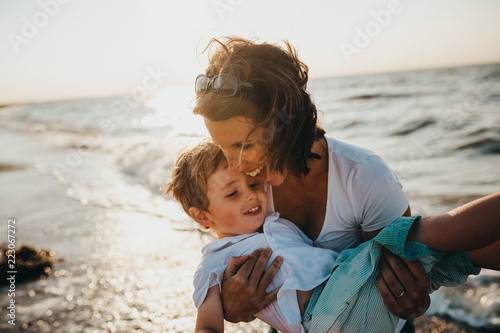 Pregnant Mother And Her Little Hhild on The Beach At Golden Hour