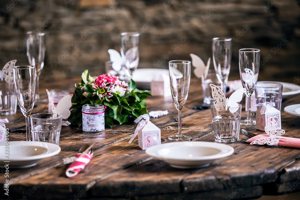 Fototapeta premium Wedding preparation - decorated wedding table settings with empty glasses and plates