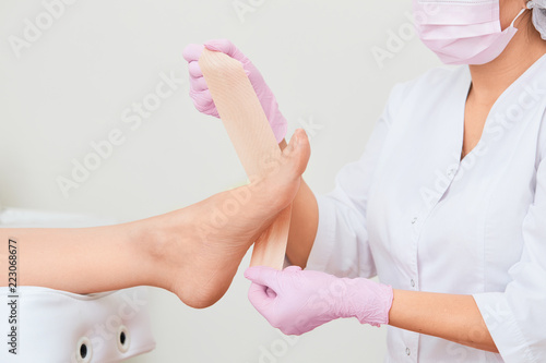 Patient on medical pedicure procedure visiting podiatrist.Podologic polymer gel plates.Protecting the skin ulceration.Bedsore prevention.Foot treatment in SPA salon.Podiatry clinic.