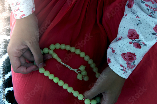 A young Muslim woman performs prayer in the mosque photo