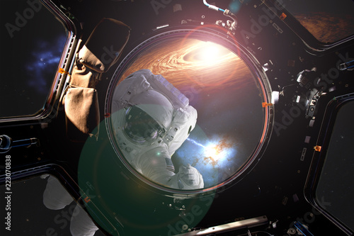 view through the space ship illuminator of astronaut in open spacce with flare frome the star (image elements were taken from NASA photo gallery) d