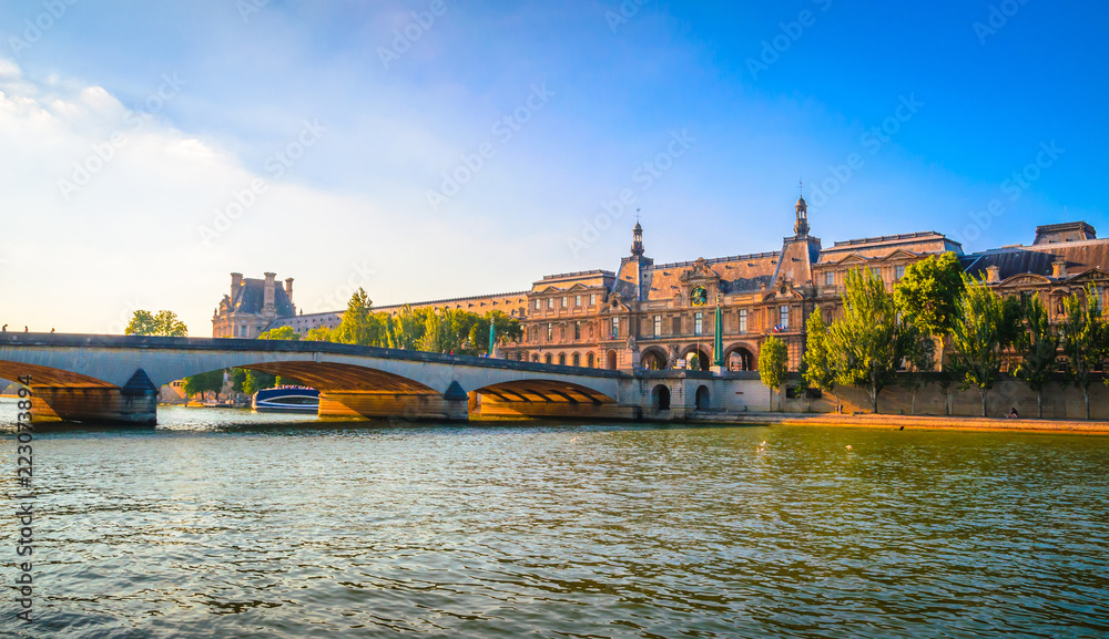  View on Pont du Carrousel and Louvre Museum from Seine river in Paris, France