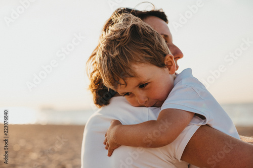 French Pregnant Mother And Her Little Boy on The Normandy Beach At Sunset