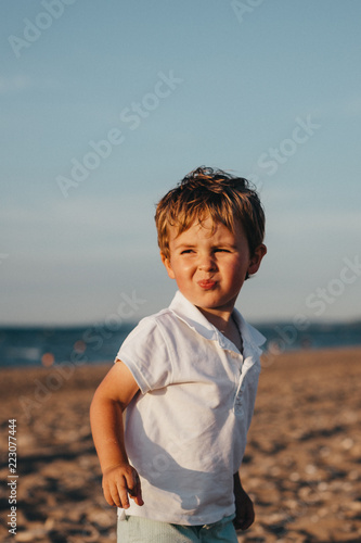 Little Boy At The Beach At Sunset