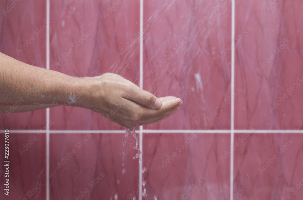 Fototapeta premium A man washes his hand