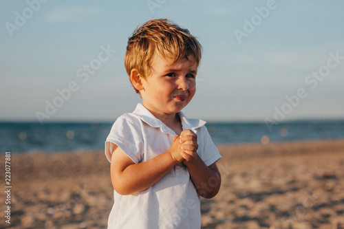 Little Boy At The Beach At Sunset