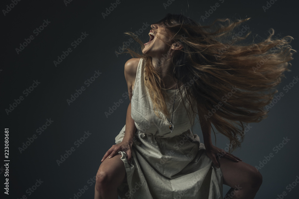 Crazy, deranged young woman screaming with frustration, expressing madness and rage - obrazy, fototapety, plakaty 