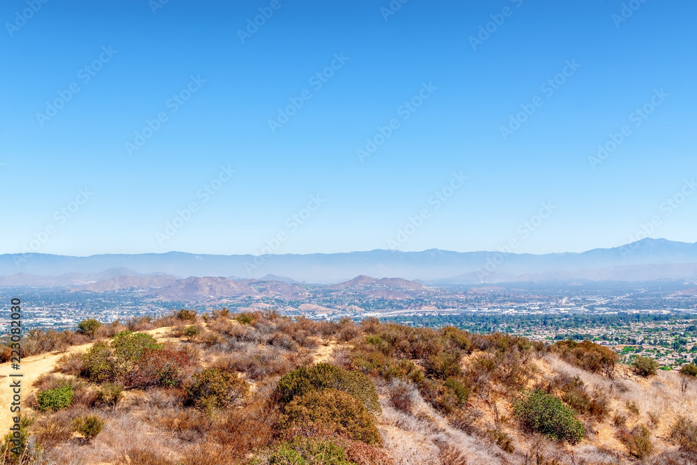 View of California mountains with cities and houses in the distance on clear sunny day