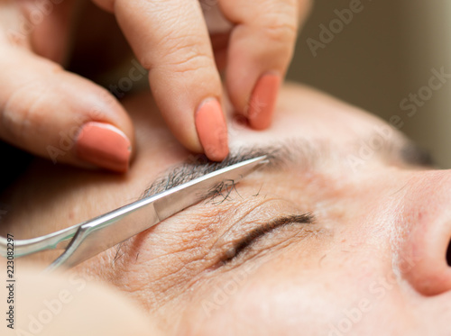 care of eyebrows in a beauty salon close-up