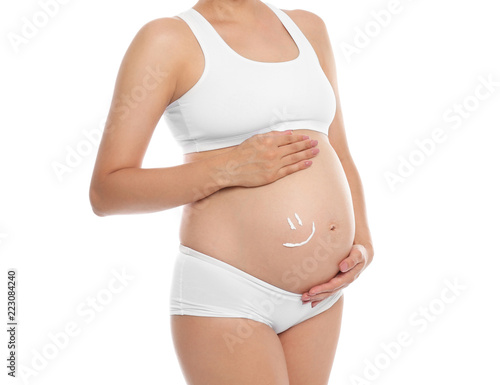 Wallpaper Mural Smile painted with body cream on pregnant woman's belly against white background, closeup Torontodigital.ca