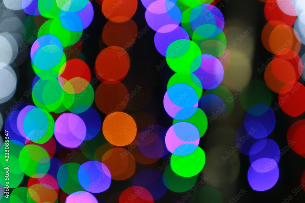 Colored Bokeh blurring lights background.