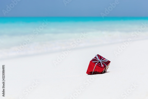 Fototapeta Naklejka Na Ścianę i Meble -  Packed gifts on sand with azur sea background