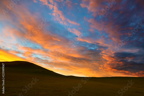 The rosy clouds of dawn on the summer grassland.