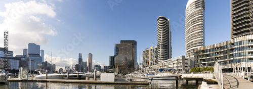 Docklands, Melbourne, Victoria, Australia. Waterfront buildings and marina, water and glass sparkling in sunshine.