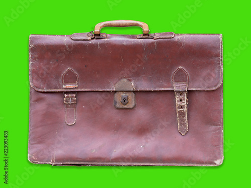 Old leather bag isolated on green background.