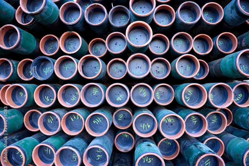 Full frame view of a rack of numbered iron pipes used for industrial oil & gas drilling Full frame view of a rack of numbered iron pipes used for industrial oil & gas drilling