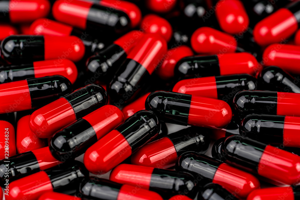 Pile of red-black capsule pills. Antibiotics resistance. Drug use with reasonable. Global healthcare concept. Antibiotics drug resistance. Antimicrobial capsule pills. Pharmaceutical industry. Pile of red-black capsule pills. Antibiotics resistance. Drug use with reasonable. Global healthcare concept. Antibiotics drug resistance. Antimicrobial capsule pills. Pharmaceutical industry.
