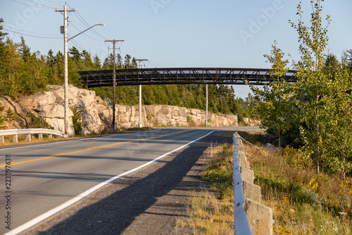 Pedway over road in late afternoon summer sun, no cars, no people. photo