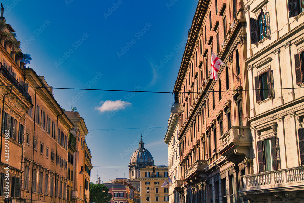 Roman street with dome of St. Paul's Basilica in background in Rome, Italy