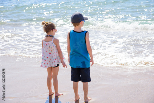 two children watching waves come in