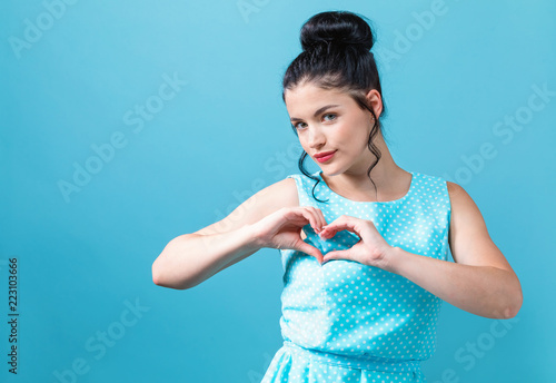 Woman making a heart shaped gesture with her hands