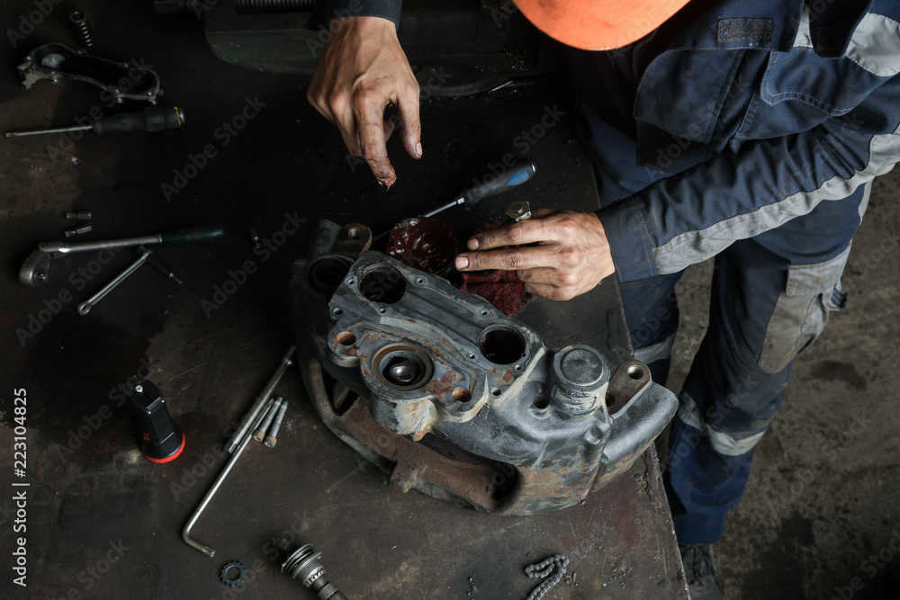The mechanic serves the truck. Repair brake caliper. Close-up. Maintenance. Brake system. Brake spare parts. Hands working close-up. The mechanic serves the truck. Repair brake caliper. Close-up. Maintenance. Brake system. Brake spare parts. Hands working close-up.