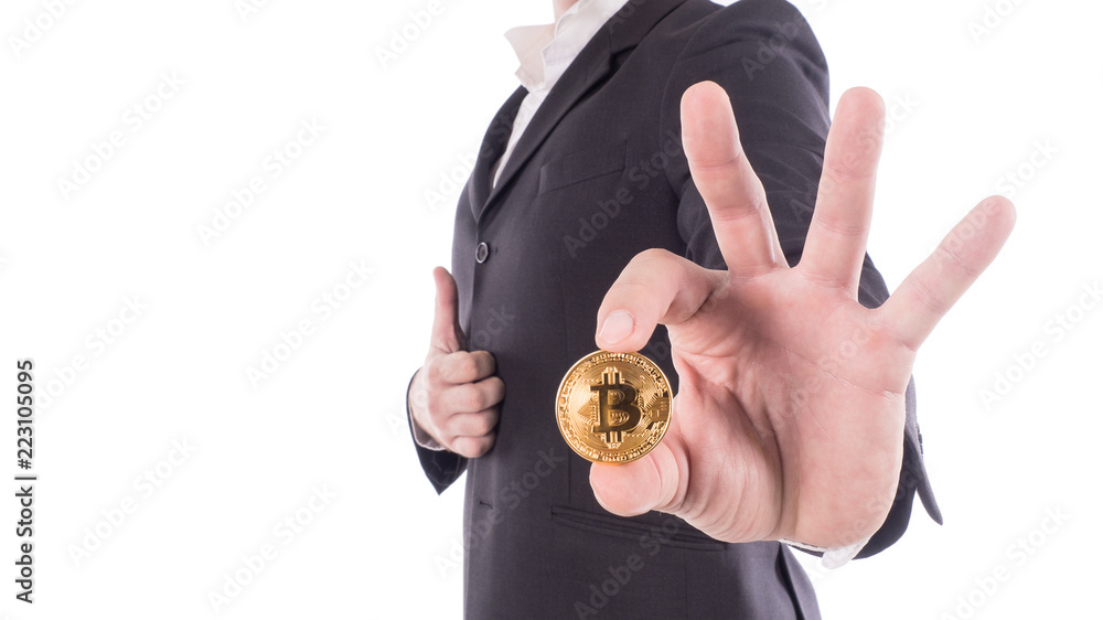 Young businessman holding bitcoin on hand. Isolated on white Young businessman holding bitcoin on hand. Isolated on white