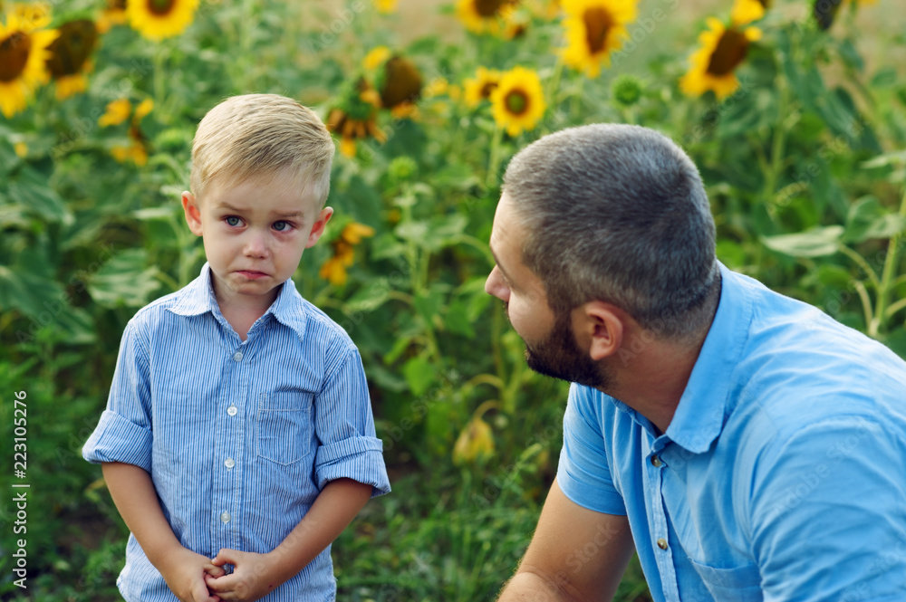 Frustrated, the son and the father . Father calms son for a walk