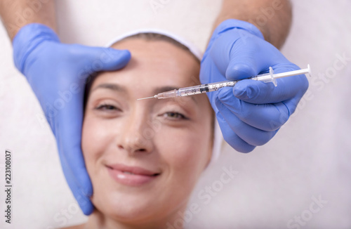 Woman in beauty salon during skin treatment with hyaluronic acid