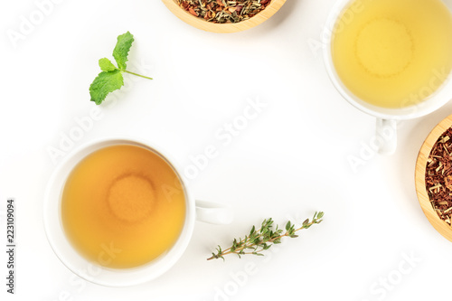 An overhead closeup photo of a cup of tea on a white background with copy space