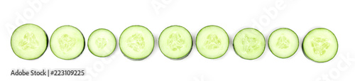 Cucumber slices forming a line on a white background with copyspace