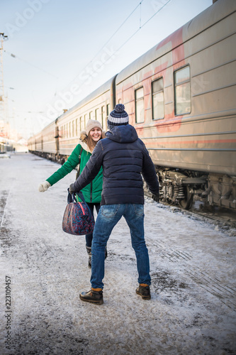 Couple meet each other after long time at railway station near train © keleny