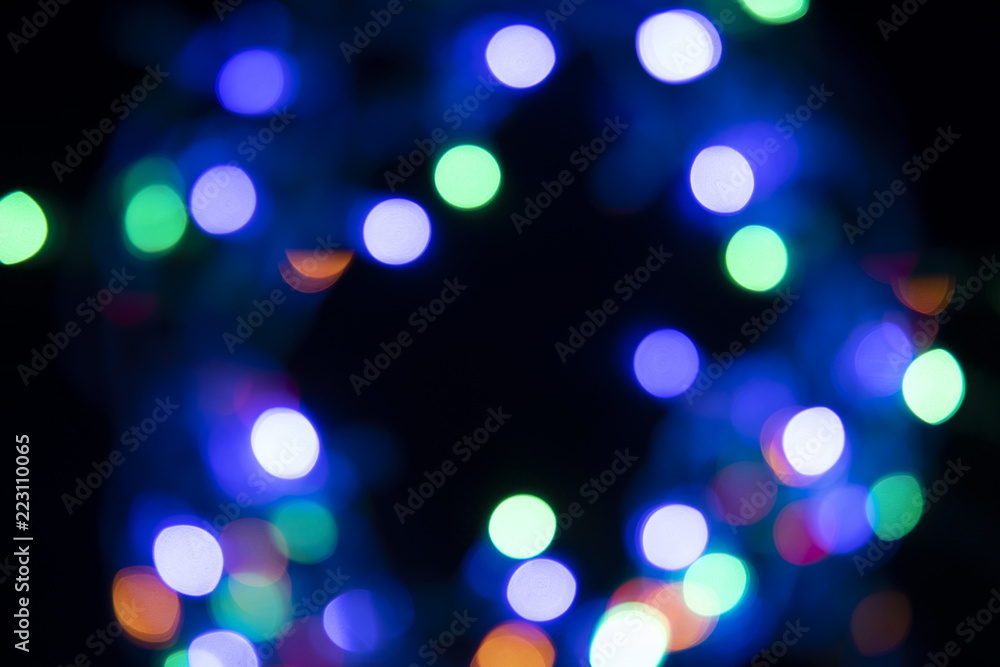 The colors of the lights are flashing blue, green, purple and orange in the form of Bokeh. The colors of the lights are flashing blue, green, purple and orange in the form of Bokeh.