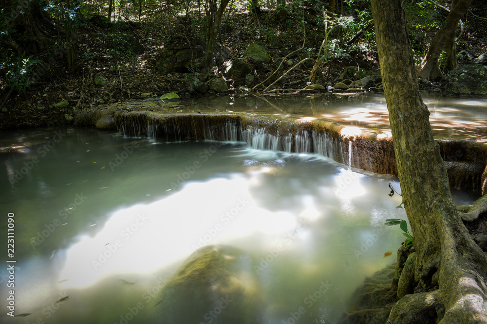 Fototapeta premium Waterfall hidden in the tropical jungle (erawan waterfall) in kanchanaburi province asia southeast asia Thailand
