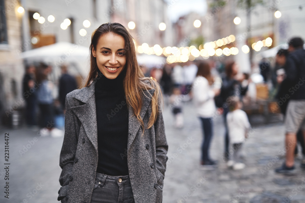 portrait of young beautiful fashionable brunette woman posing in street at autumn. portrait of young beautiful fashionable brunette woman posing in street at autumn.