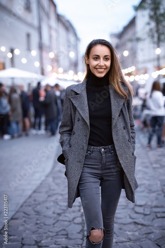 portrait of young beautiful fashionable brunette woman posing in street at autumn. © vitaliymateha