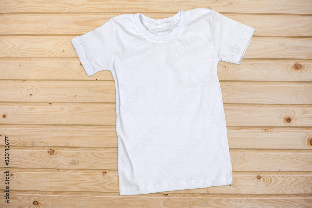White Short Sleeve T-Shirt on a Wooden Background White Short Sleeve T-Shirt on a Wooden Background