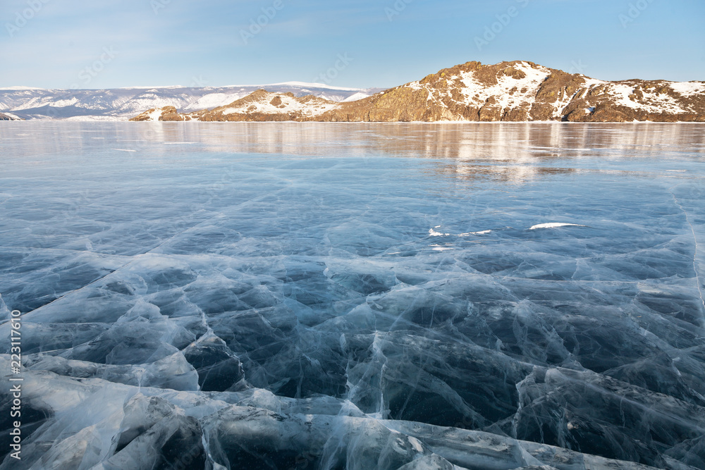 Winter morning on Baikal Lake. View from clear ice to the Mare's Head ...