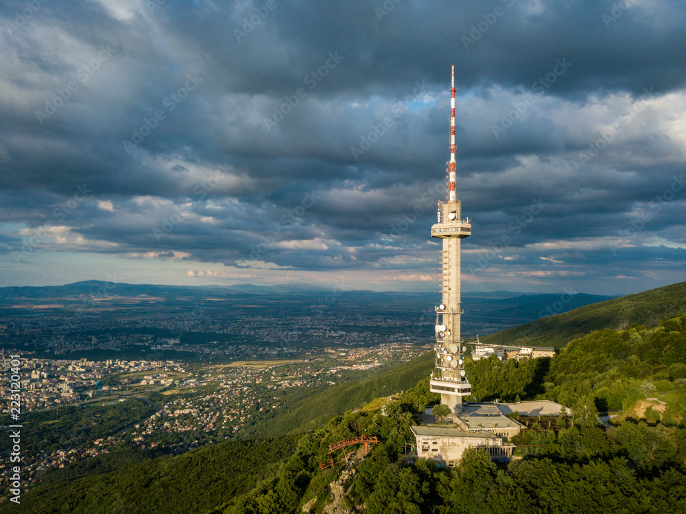 Aerial photograph of Sofia TV tower, Bulgaria - amazing scenery under the golden light of the setting sun with dark and moody skies