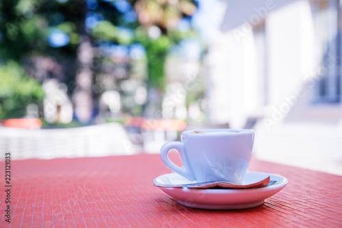 blurred background of espresso on the table in the garden