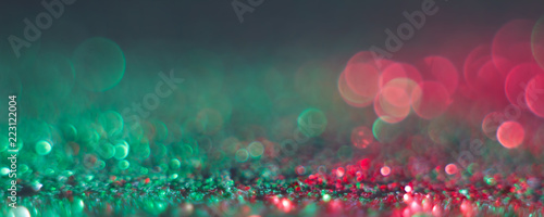 abstract defocused round shaped green and red lights on black background