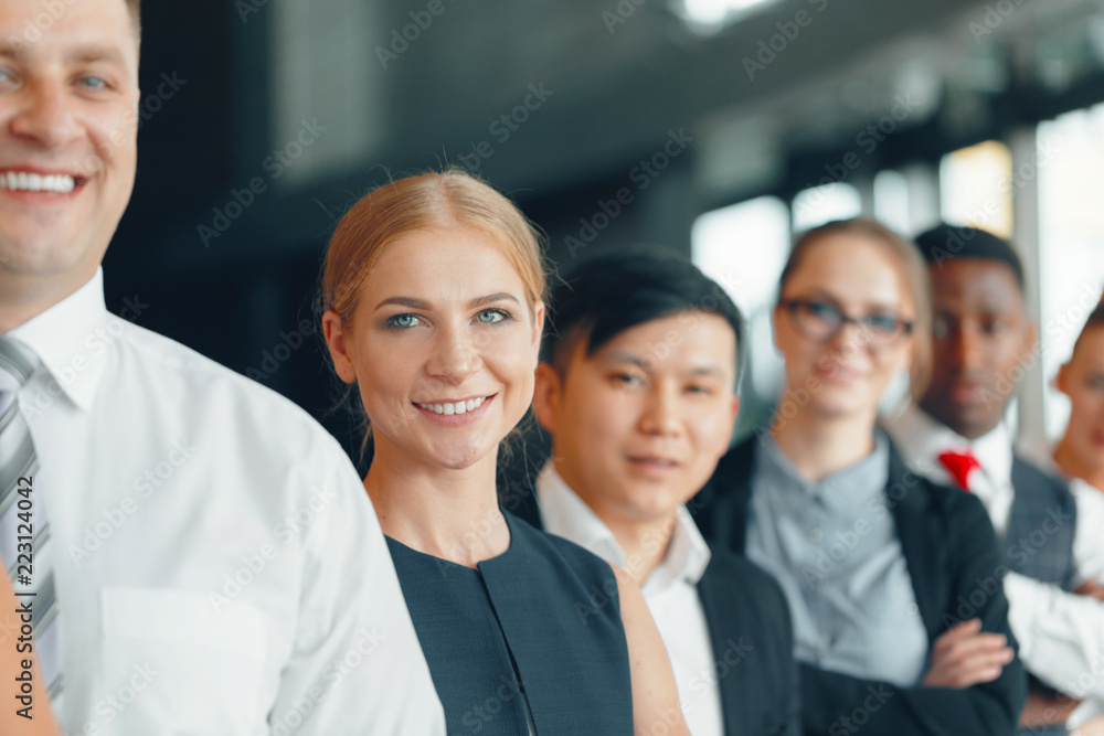 Fototapeta premium Successful team of young perspective businesspeople in office